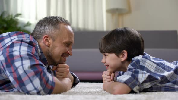 Happy Father Looking at Son, Spending Time Together on Weekend, Fatherhood