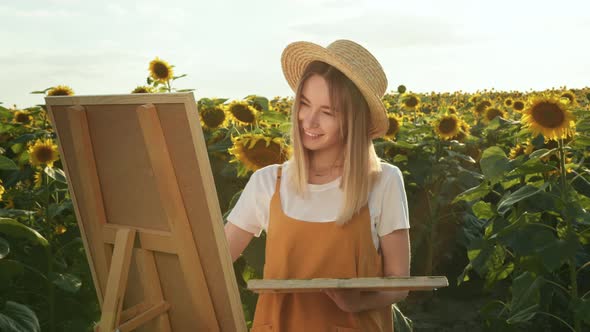 A Woman is Standing in a Field of Sunflowers and Drawing a Picture