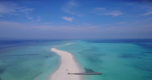 Tropical overhead tourism shot of a summer white paradise sand beach and aqua turquoise water backgr