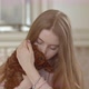 Young beautiful girl holding a poodle puppy in her arms. presses to itself. The puppy yawns. - VideoHive Item for Sale