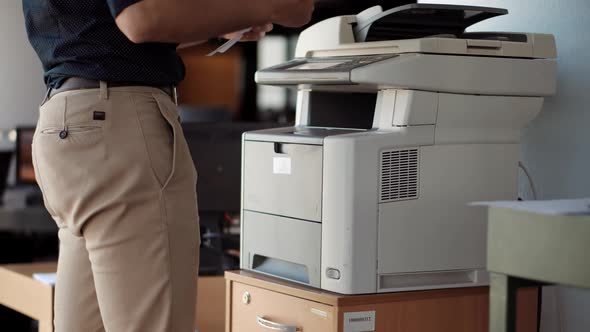 Businessman Printing Document On Workplace. Businessman Working In Office And Preparing Documents.