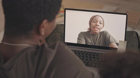 Military Woman Video Chatting with Family on Laptop alt