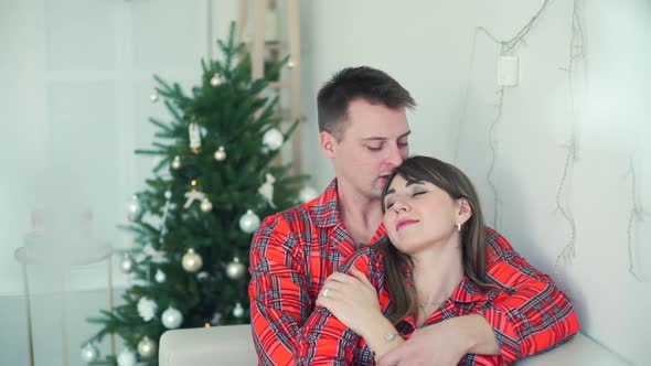 Loving Couple Hugging and Kissing in Christmas