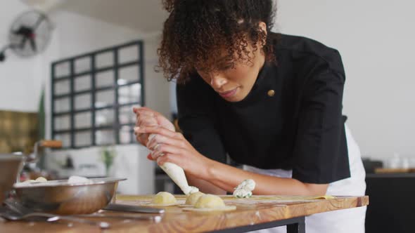 Diverse group of chefs preparing dishes and smiling in a kitchen