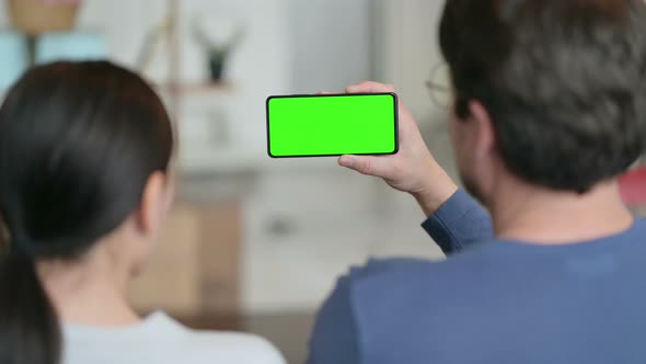 Couple Using Smartphone with Green Chroma Key Screen