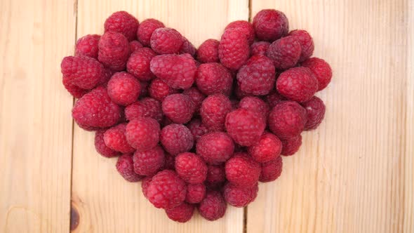 Heart Made Of Raspberry On Wooden Background. Top View. Close-Up.
