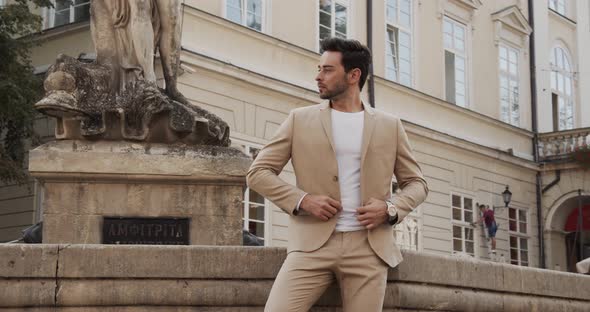 A Man In A Beautiful Suit Stands By The Fountain And Waits For A Meeting