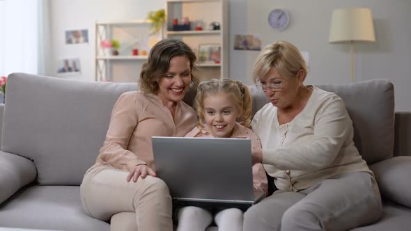 Grandmother and Daughter Teaching Child Use Laptop Application, Playing Game