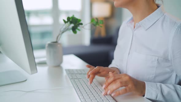 Woman with Glasses Typing on a Computer Keyboard. Concept of Remote Work