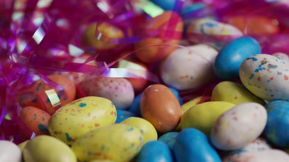 Rotating shot of colorful Easter candies on a bed of easter grass 