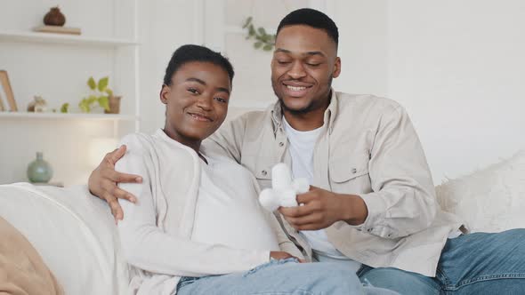 Afro American Family of Future Parents Sitting on Sofa at Home African Man Husband Father Walking