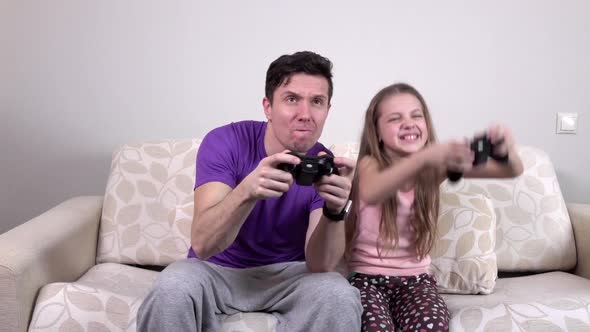 Father and Daughter Playing Computer Game at Home, Slowmotion