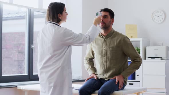 Doctor Measuring Patient's Temperature at Hospital