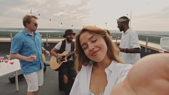 POV of Happy Woman Having Rooftop Party with Friends