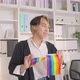 Portrait of Asian businessman gay working in office, holding LGBT flag. - VideoHive Item for Sale