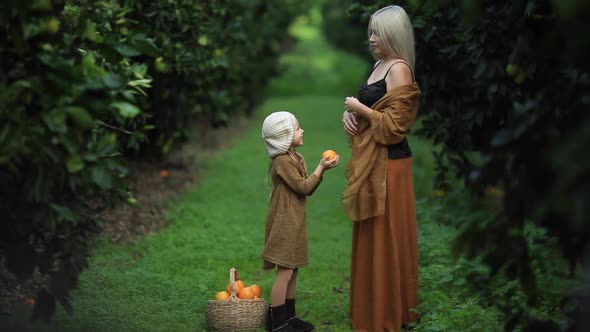 Happy Woman with Daughter in Sunny Garden Full  Slow Motion