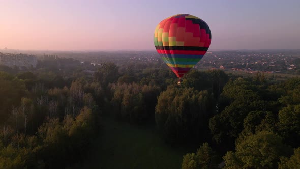 Aerial Deone View of Colorful Air Balloon Flying Over Green Park and River in Small European City at