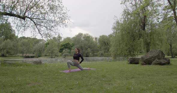 Young Sportswoman Doing Yoga in the Park