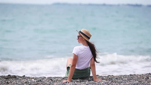 Woman Laying on the Beach Enjoying Summer Holidays Looking at the Sea