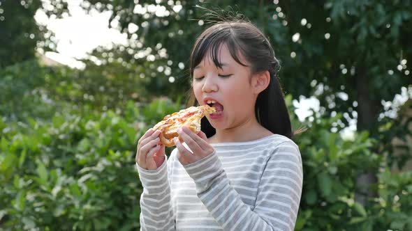 Beautiful Asian Girl Eating Eating Pizza Outdoor