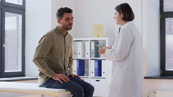 Doctor with Stethoscope and Man at Hospital