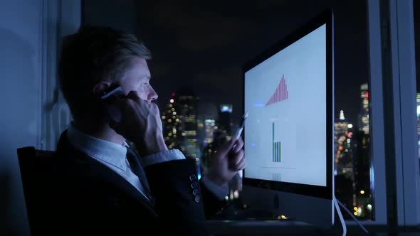 Young Businessman Working on Computer Screen in Modern City Office alt
