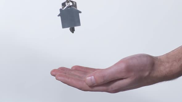 Broker Putting Key from New House in Buyer's Hand, Purchase of Real Estate