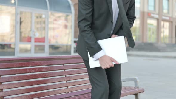 Businessman Coming Sitting on Bench and Opening Laptop