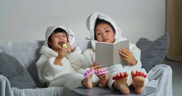 Two Asian Girls of Different Generations in Bathrobes Mother and Daughter Relax After Shower on