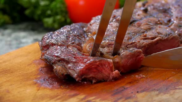 Mistress Cuts the Finished Juicy Beef Steak