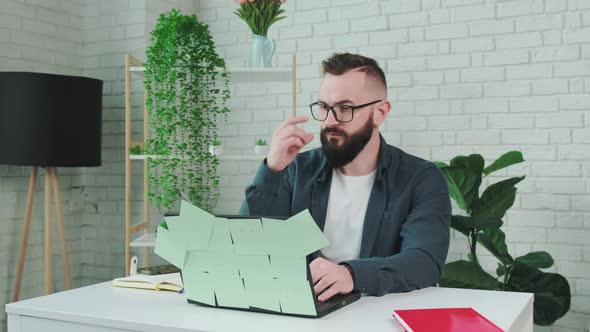 Tired Man From Working on the Computer Takes Off Glasses to Rest His Eyes