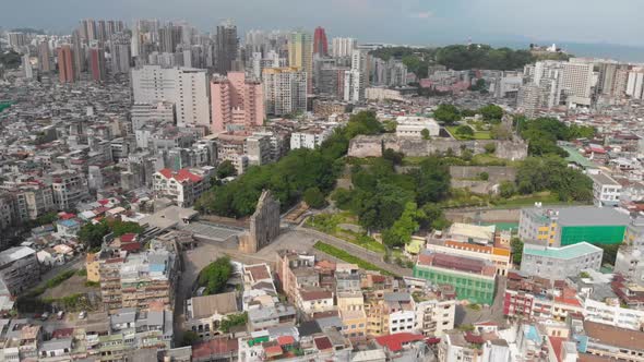 High rotating aerial view of famous Ruins of Saint Paul's and Monte do Forte, Macau