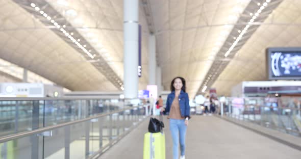 Woman looking at cellphone in airport