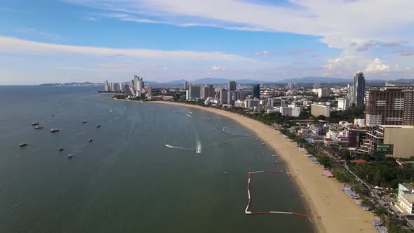 Sliding aerial view of Pattaya Beach and cityscape