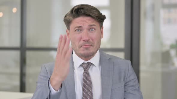 Portrait of Middle Aged Man Fighting, Arguing Towards Camera