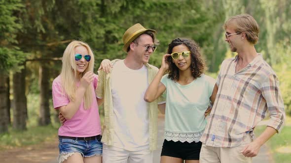 Group of Friends Hanging Out in Park on Sunny Day, Laughing at Jokes, Having Fun