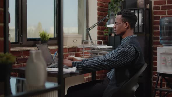 Manager Using Laptop to Work on Financial Growth in Office