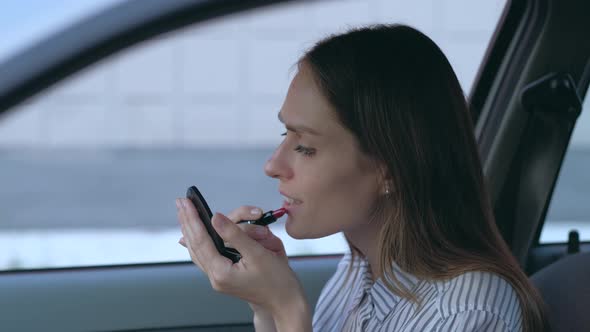 Female Doing Makeup in Car