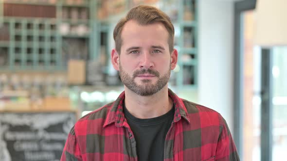 Portrait of Young Man Shaking Head, No Sign