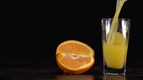 Pour the Orange Juice in a Glass Jar on a White Background and Have the Orange Juice Bottle Ready