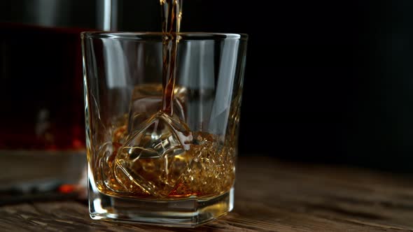 Super Slow Motion Shot of Pouring Whiskey Into Glass with Ice Cubes at 1000Fps with Camera Movement