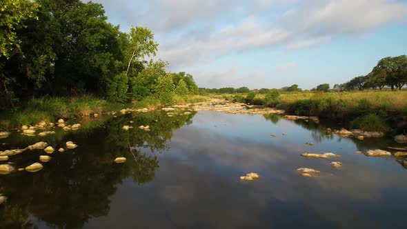Aerial footage of the Pedernales River near Stonewall Texas. Drone is flying low slow over the river