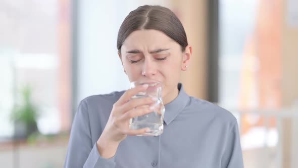 Portrait of Latin Woman Drinking Water and Having Toothache