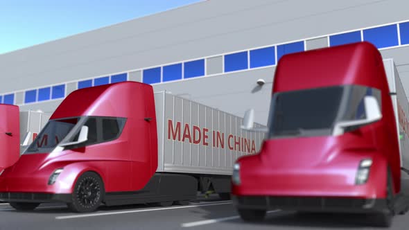 Modern Trailer Trucks with MADE IN CHINA Text at Warehouse