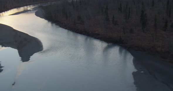 Helicopter aerial shot of Alaskan city, passing by plume of smoke, drone