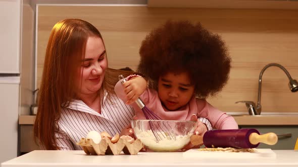 Happy Multiethnic Family Cooking Pastry Together at Kitchen