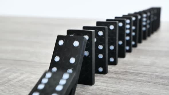 Domino Effect in Slow Motion  Falling Black Tiles with White Dots