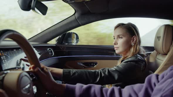 The driver drives the car, the passenger looks at the map, at the multimedia panel.