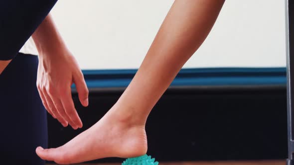 Female physiotherapist assisting patient with stress ball