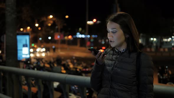Girl Using Smart Phone Voice Recognition Dictates Thoughts Voice Dialing Message at Night Evening